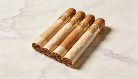 Five light-wrapper premium cigars lined up, the best mild cigars for beginners